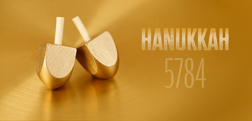 Jewish holiday Hanukkah with wooden dreidels (spinning top)