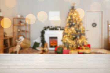 Empty wooden table in room decorated for Christmas