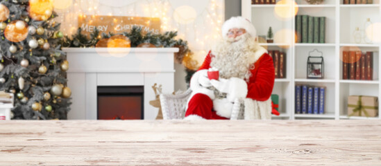Empty wooden table in living room with Santa Claus