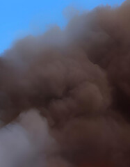 close up of fire smoke with blue sky in the background