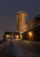 Bernardynska Gate, entrance to the Wawel castle in Krakow, Poland, on snowy night