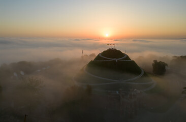Aerial view of Kosciuszko Mound in Krakow, Poland, over morning mists
