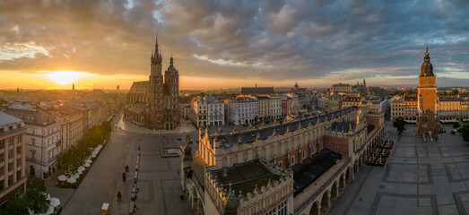 Aerial view of Main Square with St Mary's church and Cloth Hall in Krakow, Poland, during colorful sunrise - obrazy, fototapety, plakaty