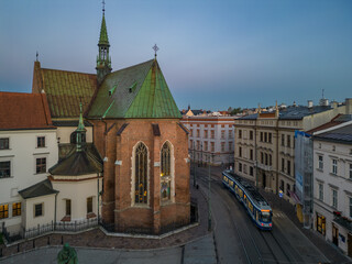Fototapeta premium Picturesque old town Franciszkanska street and St Francis church during blue hour, Krakow, Poland