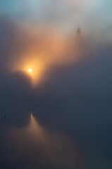Beautiful foggy sunrise with Wawel castle over Vistula river, Krakow, Poland