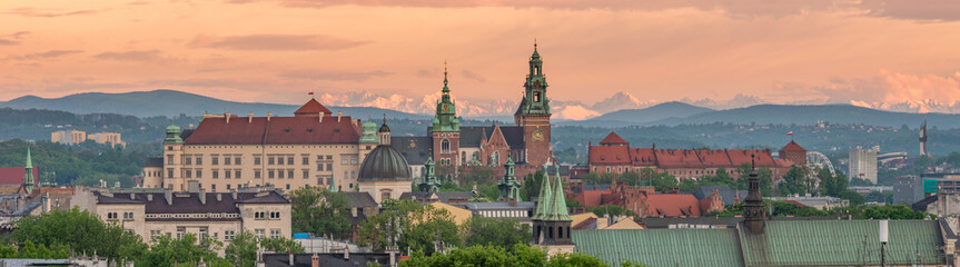 Wawel castle during colorful sunset with snowy Tatra mountains in the background, Krakow, Poland