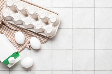 Fototapeta na wymiar Napkin with milk and eggs on white tile kitchen table