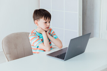 Boy doing online learning with laptop