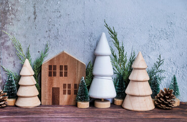 Christmas room interior decoration with wooden small houses and pine trees in Scandinavian style 