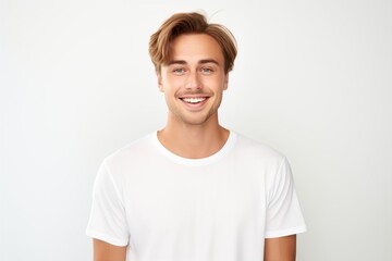 Obraz premium Handsome Fictional Male Model with Blue Eyes Smiling Candidly. Casual Clothes. Isolated on a Plain White Background. Generative AI.