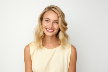 Fototapeta premium Pretty Fictional Blonde Female Model with Blue Eyes Smiling Candidly. Casual Clothes. Isolated on a Plain White Background. Generative AI.
