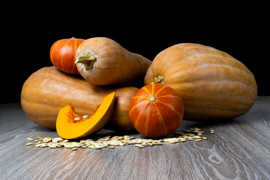 Image of pumpkin on a wooden surface providing space for products or descriptions.
Thanksgiving day or autumn pumpkin holiday.