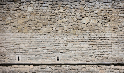 Very old brick stone wall of castle or fortress of 18th century. Full frame wall with obsolete...