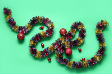 Composition with tinsel and beautiful Christmas balls on color background