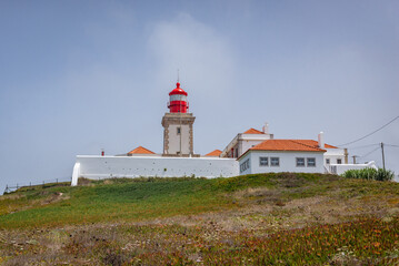 Fototapeta na wymiar Lighthouse on Cabo da Roca - Roca Cape, westernmost point of the Sintra Mountain Range and Europe, Portugal