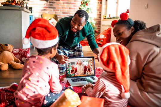 Family having video call with Santa for Christmas at home