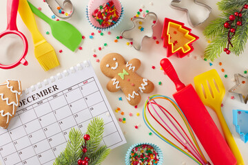 Prepare for making festive desserts. Top view composition of calendar, xmas cookies, candies, baking equipment, baking molds, fir twigs, colorful stars on light grey background