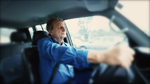 Older man driving moving car sitting inside vehicle