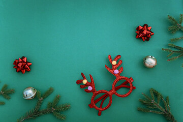 Christmas ornaments on green background. Top view with copy space.