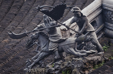 Chinese warriors figures on a pavilion roof in YuYuan, Garden of Happiness in Shanghai, China