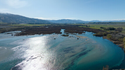 Panoramic aerial drone views of Lake Dunstan and its mountainous shoreline in central Otago