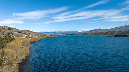 Panoramic aerial drone views of Lake Dunstan and its mountainous shoreline in central Otago
