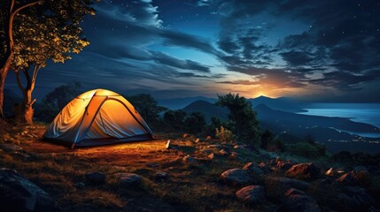 Camping tent in the mountains by the sea. Night landscape.