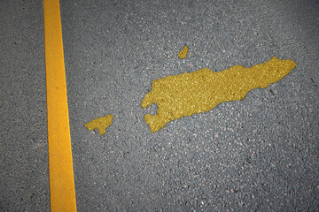 yellow map of east timor country on asphalt road near yellow line.