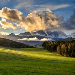landscape with clouds, forest, meadows, mountains and sky at sunset