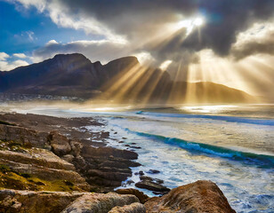 ocean breaks on shore of table mountain with sun rays