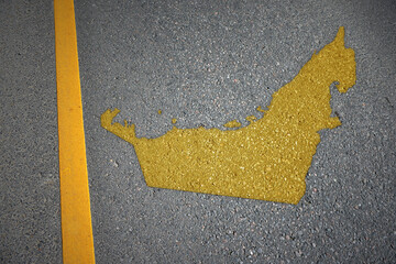 yellow map of united arab emirates country on asphalt road near yellow line.