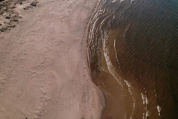 Drone aerial view of waves sea ocean coast. Beach and dunes dark calm sea waves nature landscape...