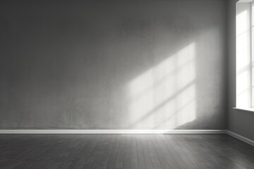 Gray room, concrete walls, light and shadow from the window directly on the wall. Empty room