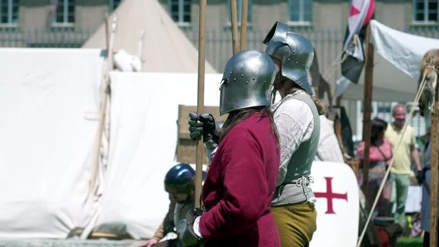 Defenders of History of Poised Soldiers with Spears at Reenactment Medieval Gathering