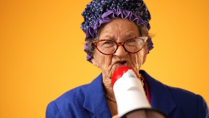 Closeup portrait of funny toothless old elderly senior crazy grandmother woman yelling into...