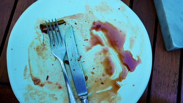 Dining Aftermath of Empty Plate with Meal Residue. Plate leftovers, finished plate