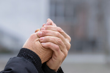 Male hands without gloves in winter.Risk of frostbite of hand outdoors during cold weather because...
