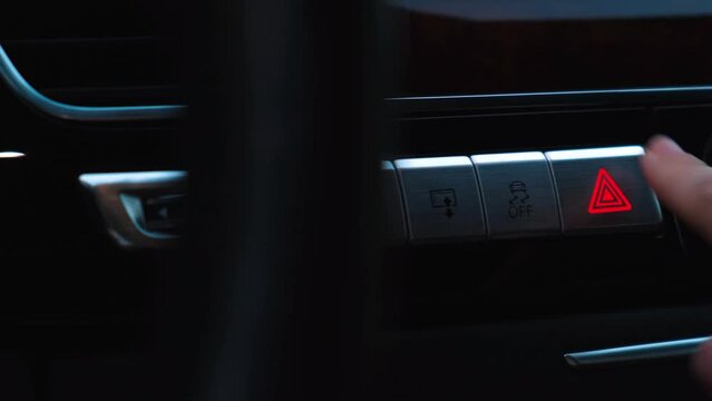 Red emergency button flashing Interior of modern luxury car. Details of automatic transmission gear shift, multimedia control system, car control panel, Air Vent and dashboard inside. Prestige sport