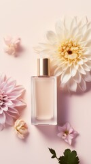 A bottle of perfume surrounded by flowers on a pink surface