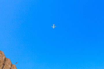 Airplane in the sky over the ancient city. Background with selective focus and copy space