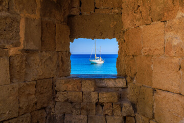 View of the yacht from the fortress wall of the island of Rhodes. Background with selective focus...
