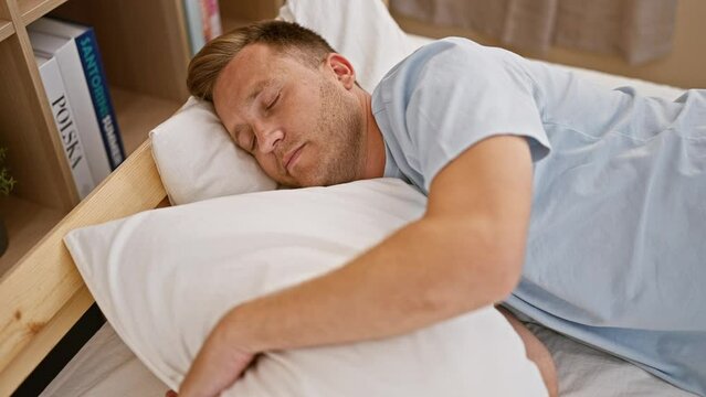 Exhausted young caucasian man relaxing in the comfort of his cozy bedroom, lying asleep on a comfortable bed; the very picture of a tired guy seeking restful sleep indoors