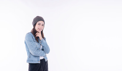 Confident asian mixed race women wear denim jacket knit cap looking at copy space on isolated white...