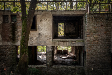 Outdoor facade of the ruins of a demolished residential building decaying in an urban environment...