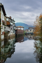 Fototapeta na wymiar Elizondo's riverside charm, autumnal elegance, cloudy day in Navarra, Spain