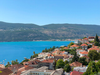 Fototapeta na wymiar Tile roofs of Herceg Novi and the bay of Kotor