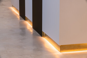 Illuminated baseboard in modern house