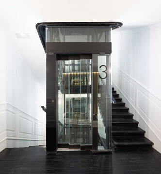 Glass elevator in lobby of modern residential