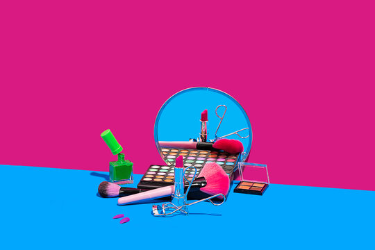 Assorted makeup products on colorful background
