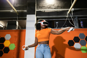 Woman Experiencing Virtual Reality in a Gaming Arena